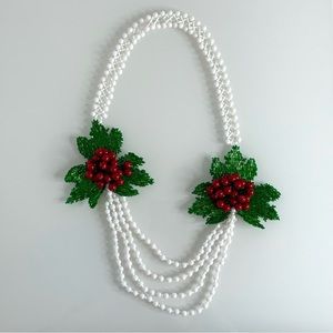 Hand beaded white necklace with cranberry inspired details and green leaves